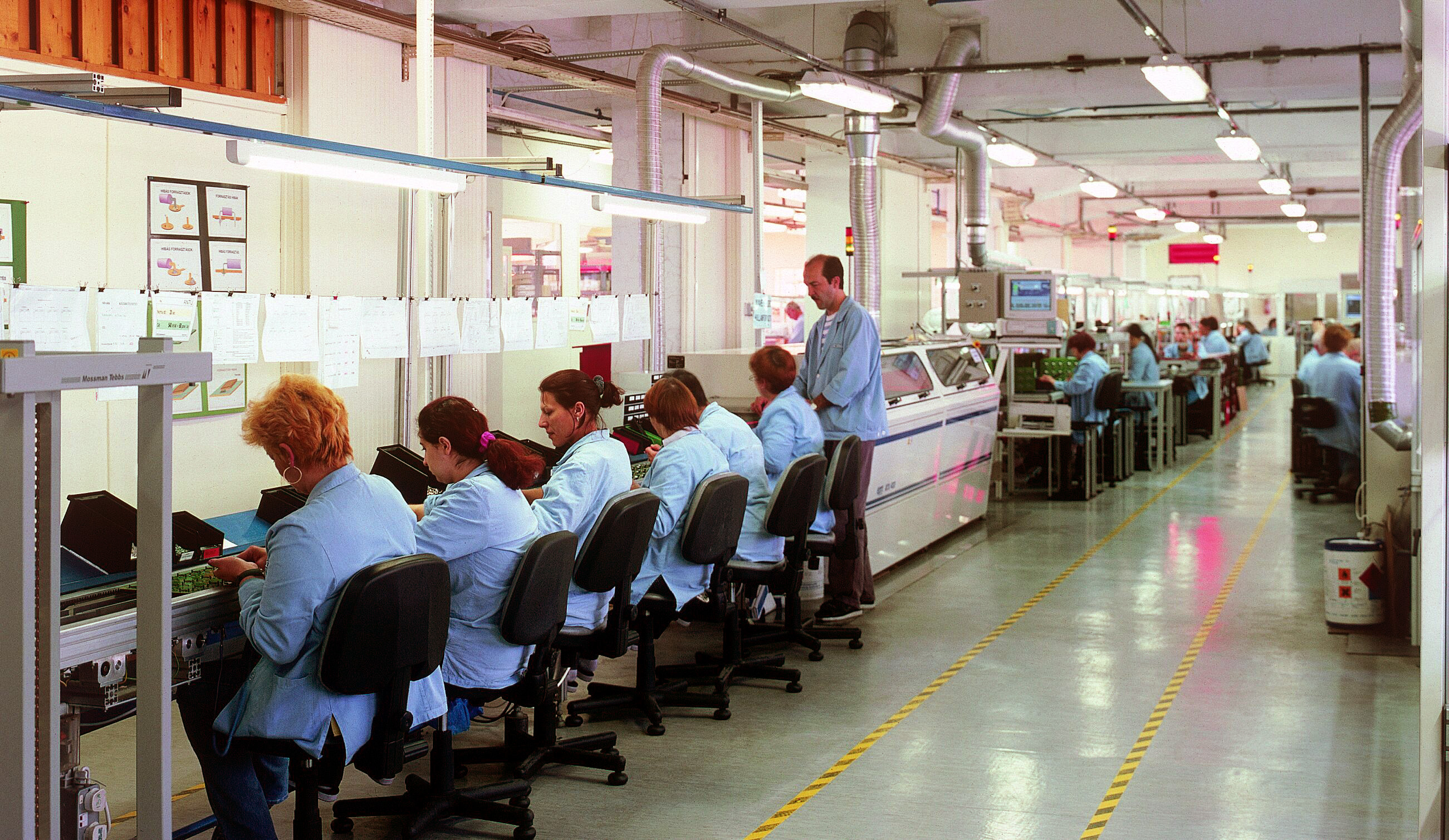 Photograph of workers on an Orion electronics assembly line in Hungary